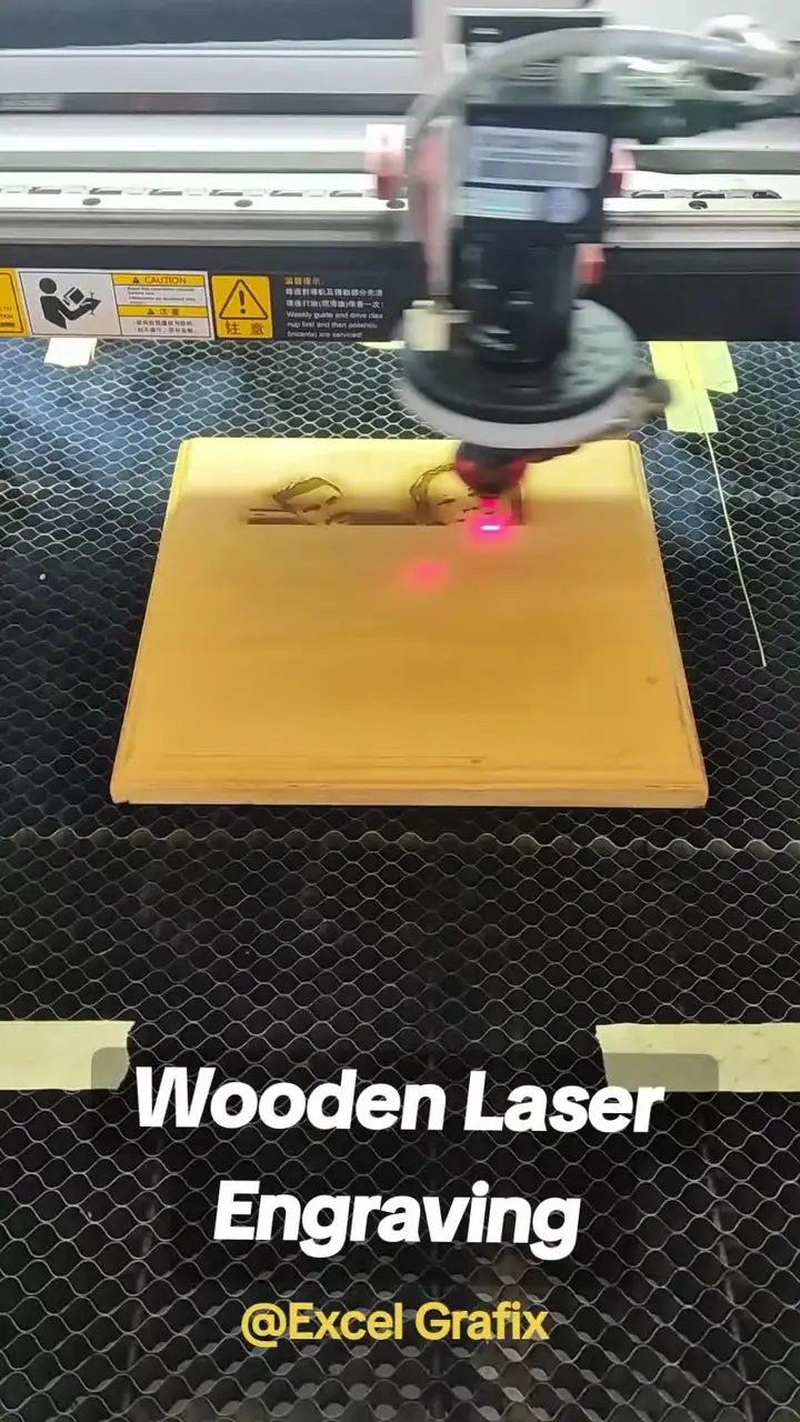 Laser cutter engraving a wooden board in the studio