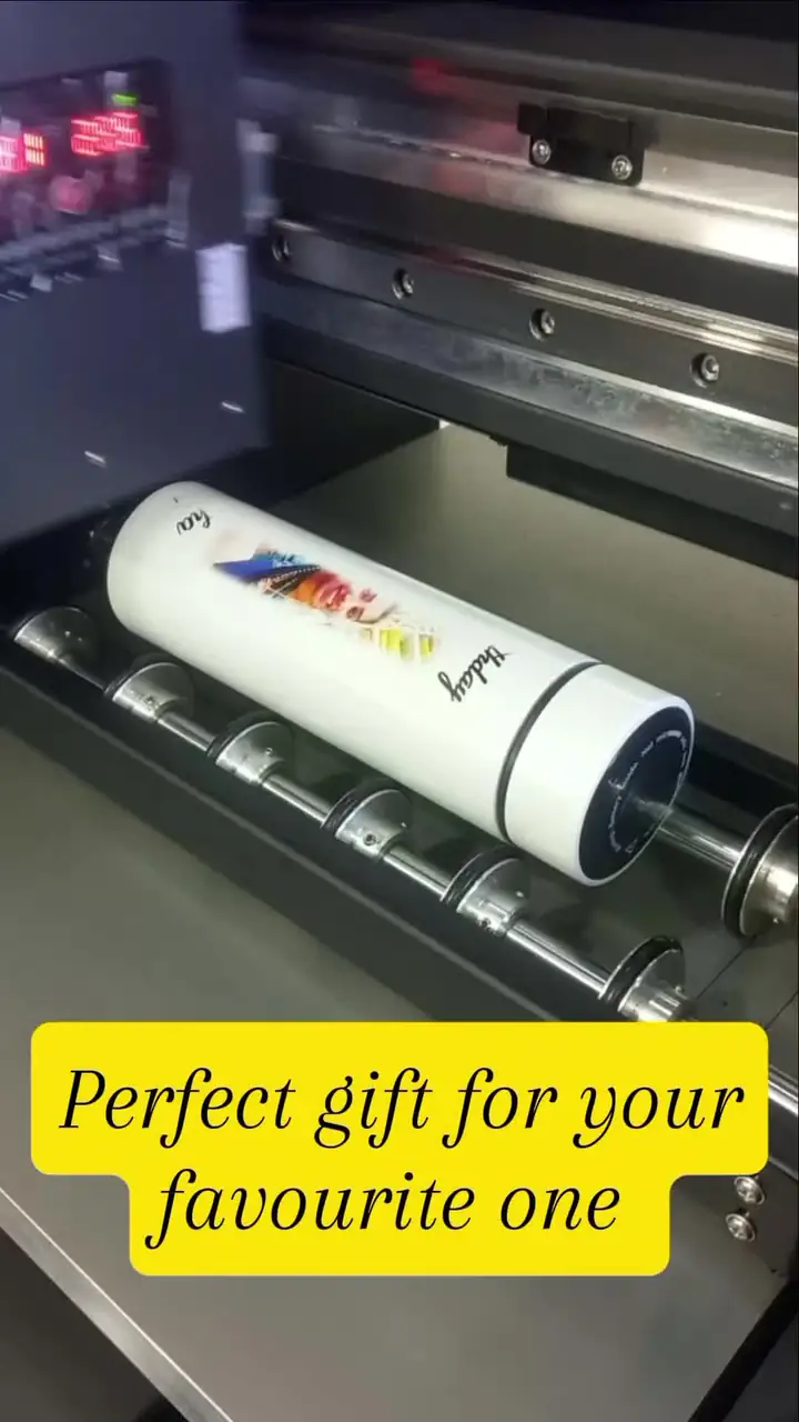 White bottle UV-printed with a colourful design on the printer